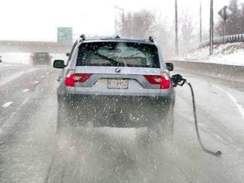 gas pump attached to car