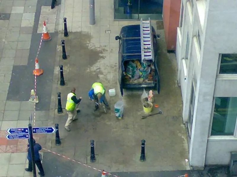 workers repairing sidewalk